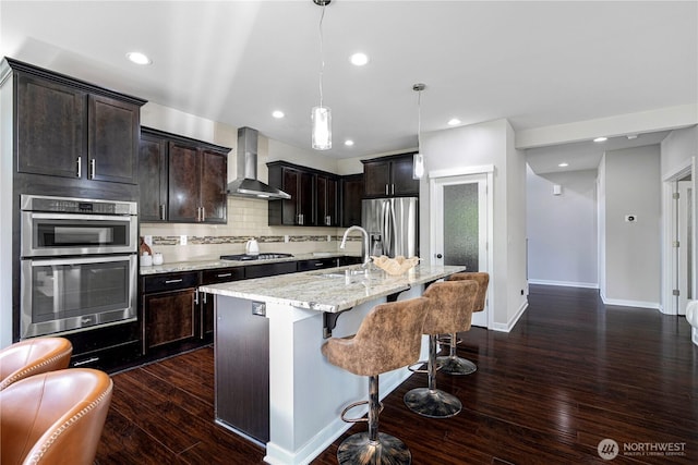 3804 193rd Pl SE, Bothell, WA 98012 - kitchen with a breakfast bar area, a sink, wall chimney exhaust hood, tasteful backsplash, and appliances with stainless steel finishes