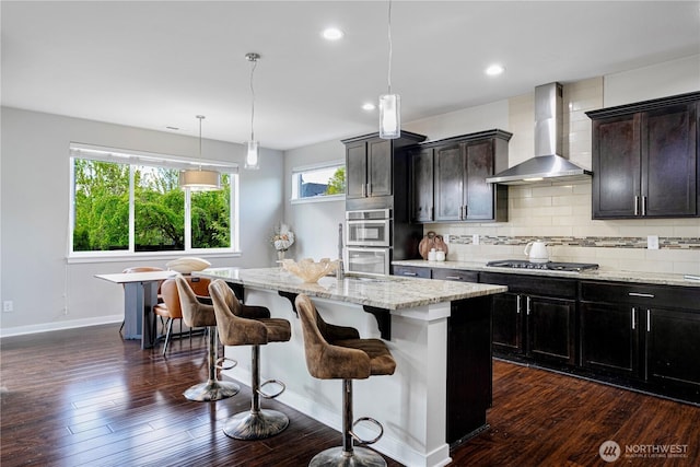 3804 193rd Pl SE, Bothell, WA 98012 - kitchen featuring wall chimney range hood, stainless steel appliances, dark wood-style floors, and a kitchen island with sink