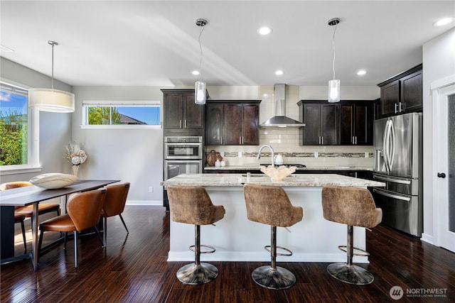 3804 193rd Pl SE, Bothell, WA 98012 - kitchen featuring light stone countertops, wall chimney exhaust hood, dark wood finished floors, and appliances with stainless steel finishes