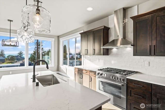 148 Henning Dr, Camano Island, WA 98282 - kitchen with wall chimney exhaust hood, high end stainless steel range oven, a sink, light countertops, and decorative backsplash