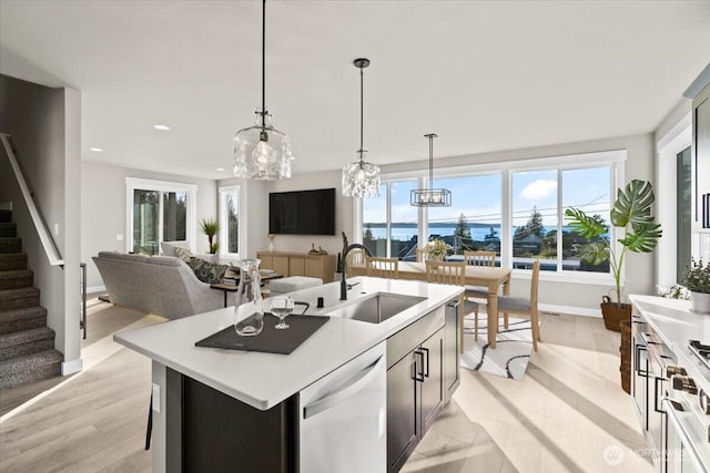 148 Henning Dr, Camano Island, WA 98282 - kitchen with dishwashing machine, a sink, light countertops, an island with sink, and recessed lighting