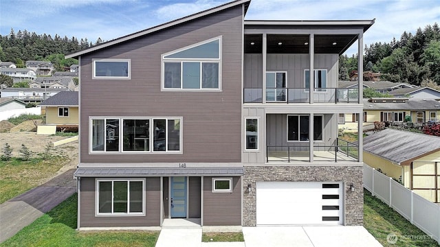 148 Henning Dr, Camano Island, WA 98282 - contemporary house with a balcony, board and batten siding, stone siding, and an attached garage