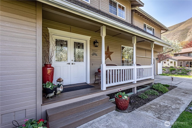property entrance featuring covered porch and a mountain view