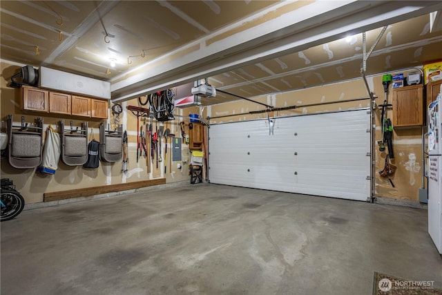 garage featuring a garage door opener and electric panel