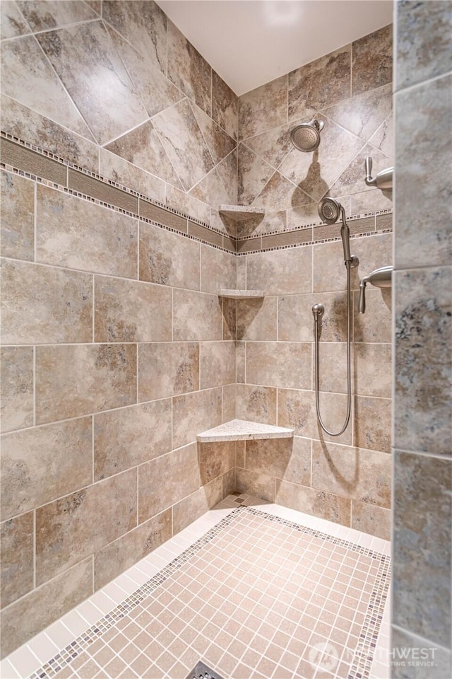 bathroom with a tile shower