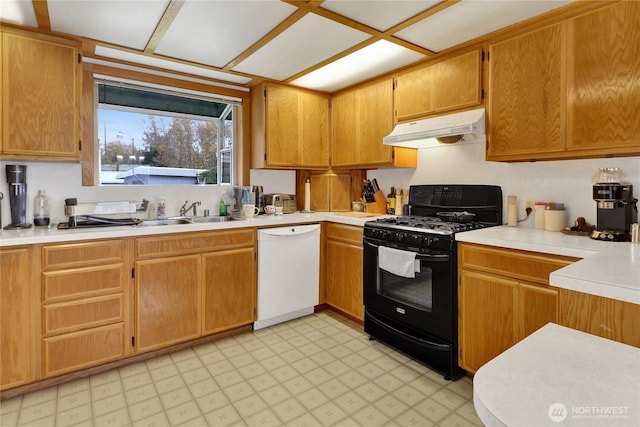 kitchen with a sink, under cabinet range hood, black gas stove, white dishwasher, and light floors