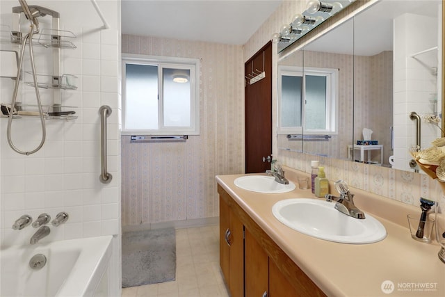 bathroom featuring wallpapered walls, tile patterned flooring, shower / bath combination, and a sink