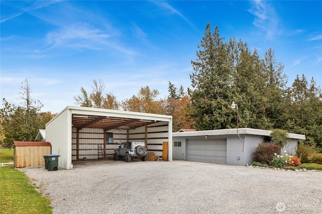 garage with a garage and gravel driveway