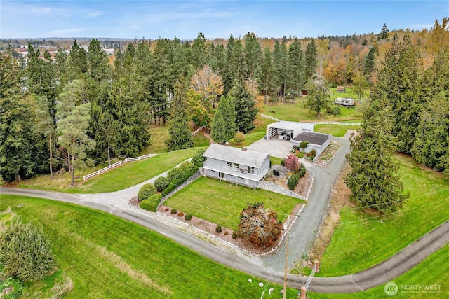 birds eye view of property featuring a view of trees