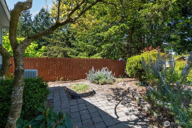 view of patio / terrace featuring central AC and fence