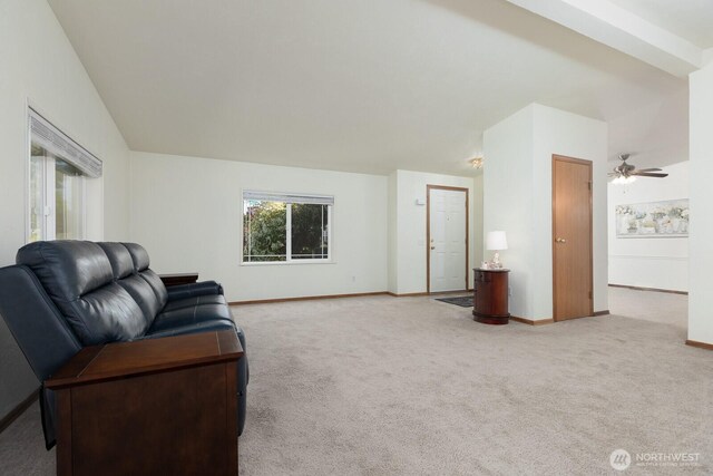 carpeted living room with baseboards and ceiling fan