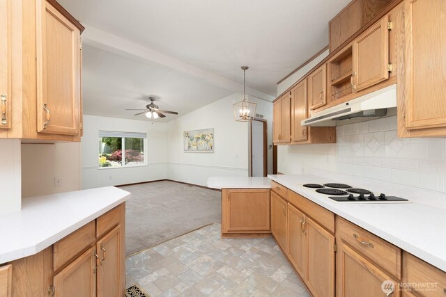 kitchen with light countertops, white electric cooktop, under cabinet range hood, and light colored carpet