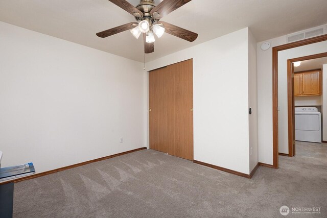 unfurnished bedroom with washer / dryer, baseboards, carpet, and visible vents