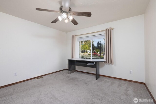 carpeted empty room with visible vents, a ceiling fan, and baseboards