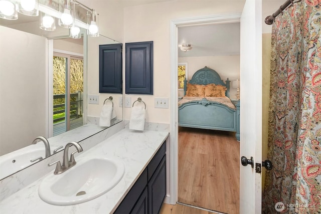 ensuite bathroom with wood finished floors, vanity, ensuite bath, and a shower with shower curtain