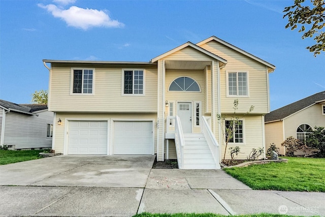 split foyer home with a garage, driveway, and a front yard