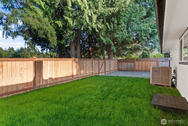 view of yard featuring a patio, a fenced backyard, and central air condition unit