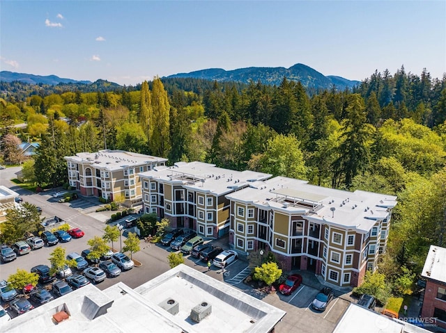 drone / aerial view with a mountain view and a forest view