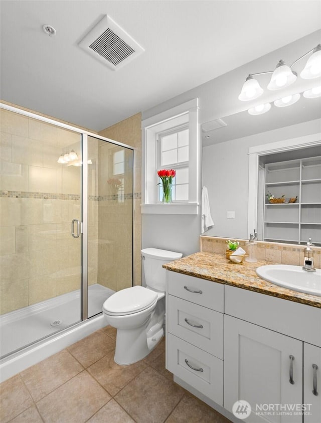 full bathroom with vanity, tile patterned floors, visible vents, and a stall shower