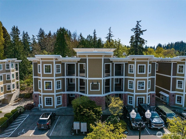 view of building exterior with uncovered parking