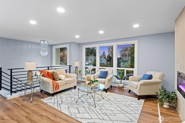 living area with wood finished floors and recessed lighting