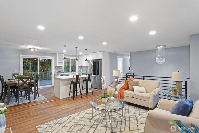 living area with light wood-style floors and recessed lighting