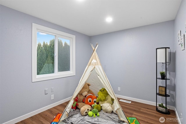 game room featuring visible vents, wood finished floors, and baseboards
