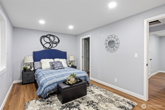 bedroom with wood finished floors and baseboards