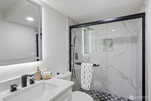 full bath featuring vanity, toilet, a marble finish shower, a textured wall, and radiator heating unit