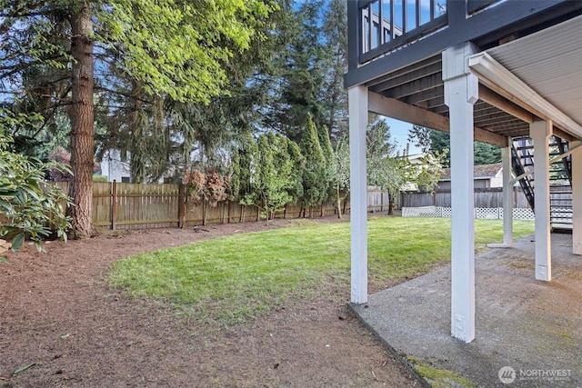 view of yard featuring stairs and a fenced backyard
