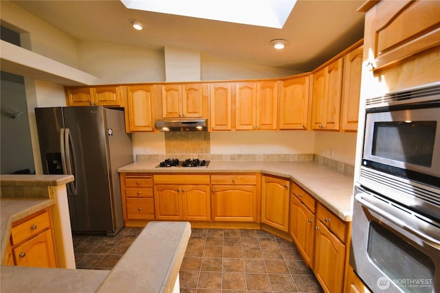 21628 SE 272nd Pl Unit 138, Maple Valley, WA 98038 - kitchen with a skylight, stainless steel fridge, under cabinet range hood, light countertops, and lofted ceiling