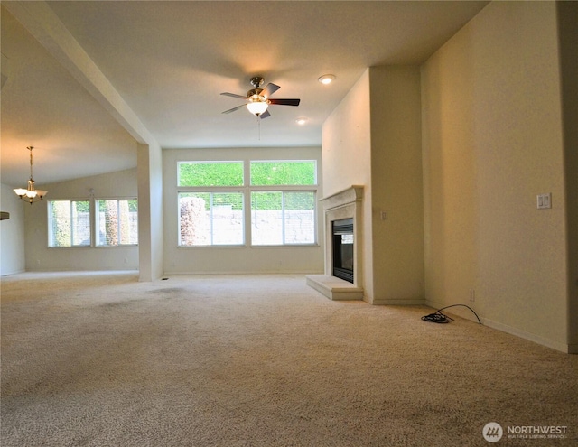 21628 SE 272nd Pl Unit 138, Maple Valley, WA 98038 - unfurnished living room featuring a ceiling fan, a glass covered fireplace, carpet floors, and a chandelier