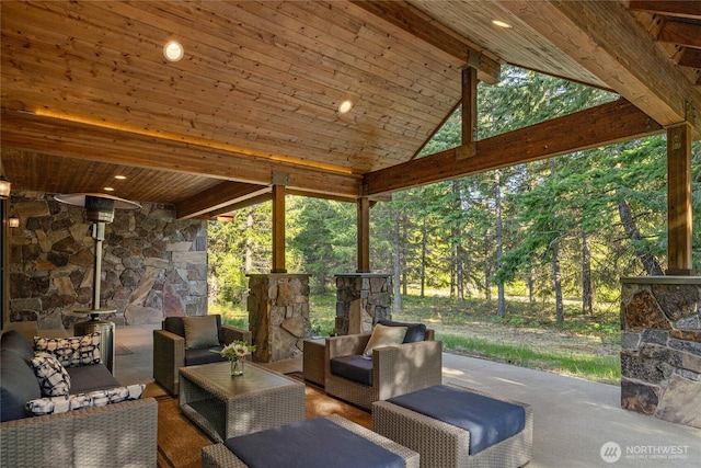 view of patio with an outdoor living space with a fireplace