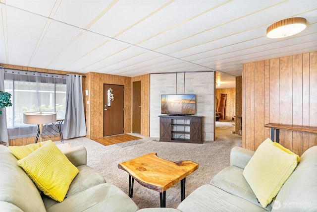 carpeted living room with wooden walls