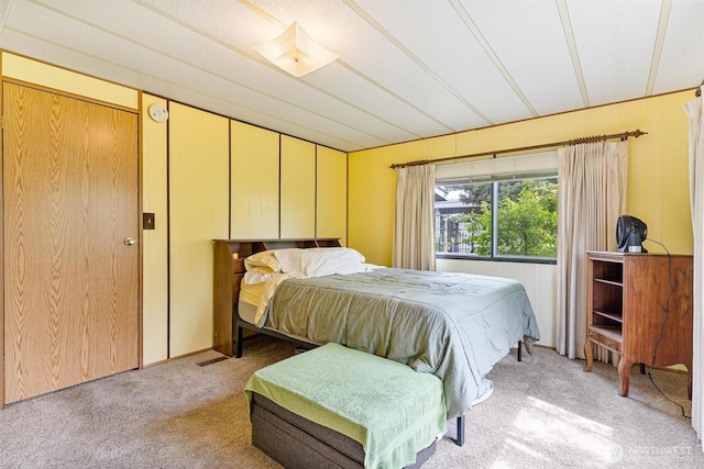bedroom featuring light carpet
