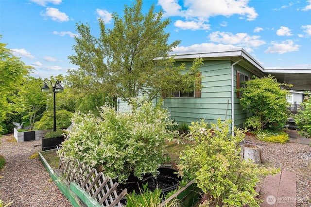 view of property exterior with a garden