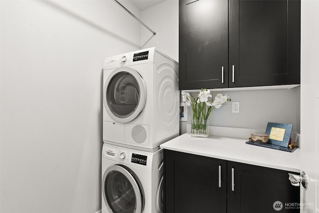 washroom with cabinet space and estacked washer and dryer