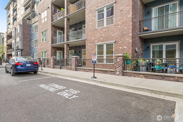 view of apartment building / complex with uncovered parking