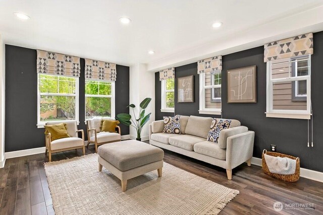 living room featuring recessed lighting, baseboards, and dark wood-style flooring