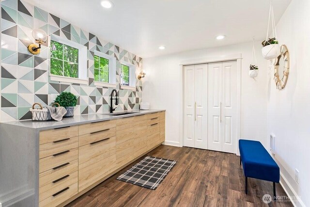 bar featuring backsplash, a sink, baseboards, dark wood-style floors, and recessed lighting