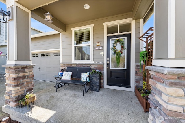 property entrance featuring a garage, covered porch, and stone siding