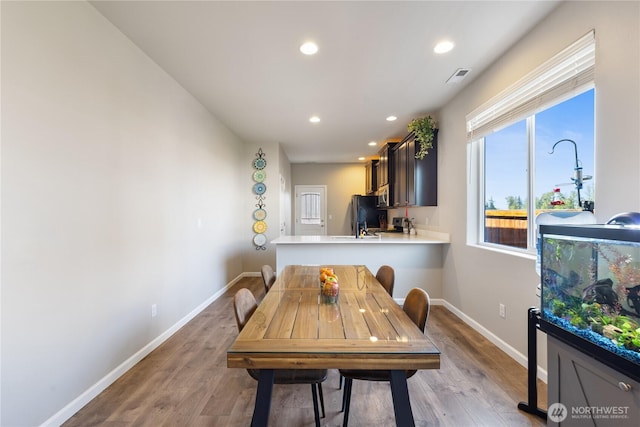 dining room with recessed lighting, visible vents, wood finished floors, and baseboards
