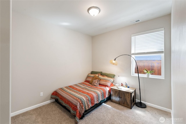 bedroom with visible vents, light colored carpet, and baseboards