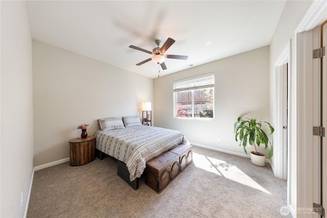 carpeted bedroom with a ceiling fan and baseboards