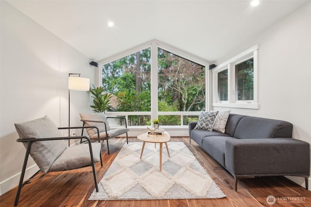 living room with recessed lighting, vaulted ceiling, wood finished floors, and baseboards