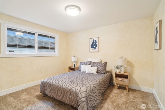 bedroom with baseboards and carpet