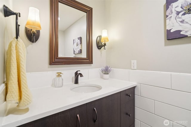 bathroom with tile walls and vanity