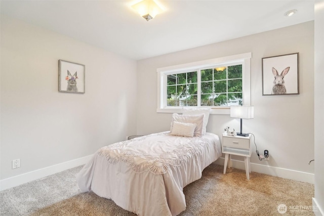 carpeted bedroom featuring baseboards