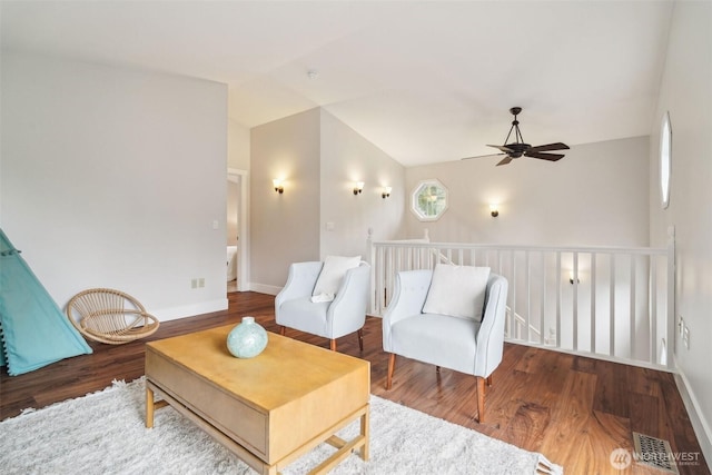 living room with lofted ceiling, wood finished floors, ceiling fan, and visible vents