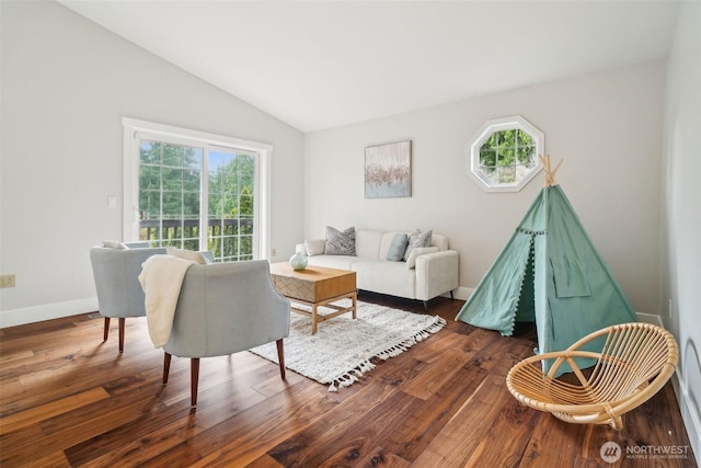 living room featuring lofted ceiling, a healthy amount of sunlight, and dark wood-style floors